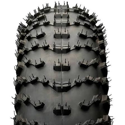 Close-up of a tire with deep tread pattern on a white background
