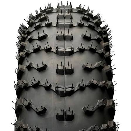 Close-up of a tire with deep tread pattern on a white background